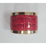 Aspinal of London gilt-coloured bangle set with red faux-snakeskin, marked to bangle, with guarantee