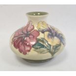 Moorcroft pottery vase of squat baluster form, tube-lined floral decoration on a yellow and green