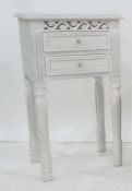Modern painted bedside table fitted with two short drawers, with carved decoration, 40cm wide