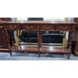 Modern hall table, the rectangular top with four drawers, raised on turned and reeded supports,