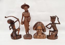 Assorted 20th century Eastern carved figures to include figure in hat carrying jug and basket,