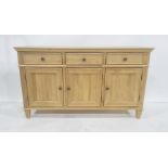 Modern oak sideboard, the rectangular top above three drawers, three cupboard doors, on square