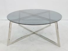 Circular coffee table with smoked glass top, chrome X-shaped base