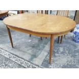 1970's G-Plan style teak extending dining table of oval form on tapering circular supports, 112 x