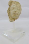 Possibly clay head after a Roman original of female form Condition ReportThe head is 13cm high x 9cm