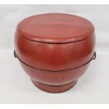 Red lacquered Chinese rice box of ogee form, thin iron banding and iron handles, 38cm high