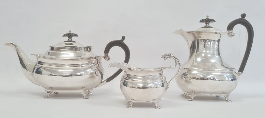 A 1920s matched three-piece silver teaset, reeded and repousse floral decoration to edges, claw