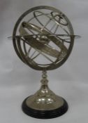 Modern metal armillary sphere on ebonised base, 53cm high