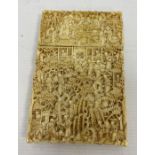 A 19th century Chinese Canton carved ivory card case, relief of figures amongst buildings and trees,