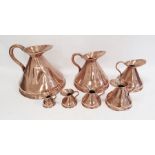 Set of seven antique graduated copper conical jug measures