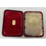 A Victorian silver card case, engraved decoration of scrolls surrounding putti, waterfall and