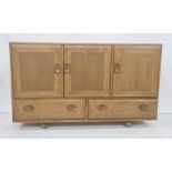 Ercol elm sideboard, the rectangular top above three cupboard doors, two drawers under, to