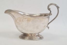 A 1920s silver sauceboat, with scroll handle, London 1923, maker's mark worn, 4.6toz. approx. 10cm