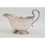 A 1920s silver sauceboat, with scroll handle, London 1923, maker's mark worn, 4.6toz. approx. 10cm