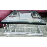 Square glass-topped coffee table on polished metal club fender-type base