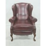 Modern red leather wing back reclining chair on cabriole front legs