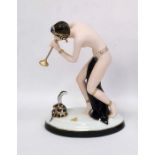 Royal Dux tinted bisque and glazed porcelain figure of a semi-nude snake charmer, on oval base, 23.