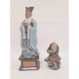 Chinese tinted bisque and partly glazed figure of a sage in blue robes and on square ceramic