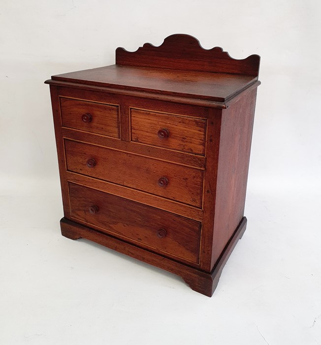 Stained wood miniature chest of drawers with raised shaped back, of two short and two long