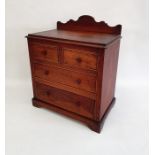 Stained wood miniature chest of drawers with raised shaped back, of two short and two long