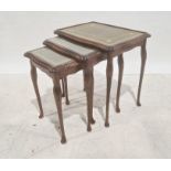 Nest of three 20th century mahogany and leather-topped coffee tables