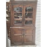 20th century oak corner display unit with two glazed doors enclosing shelves above two cupboard