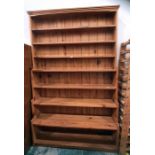 Large pine waterfall bookcase of seven shelves, moulded cornice, plinth base, 140cm x 223cm