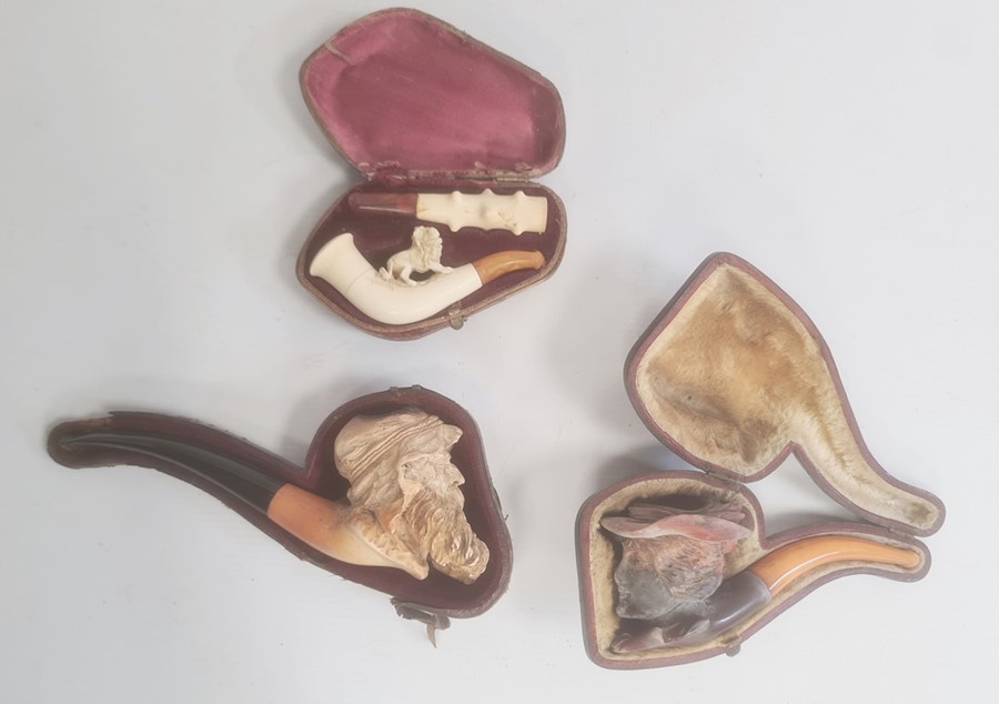 Meerschaum pipe lion decorated, a twig-pattern cheroot holder, cased, a meerschaum and amber