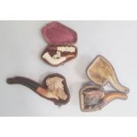 Meerschaum pipe lion decorated, a twig-pattern cheroot holder, cased, a meerschaum and amber