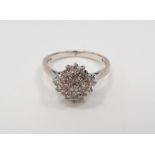 18ct white gold diamond cluster ring set with four brilliant cut diamonds within a border of further
