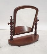 19th century mahogany-framed arched-top swing mirror on turned supports and bowfront base