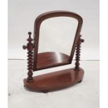 19th century mahogany-framed arched-top swing mirror on turned supports and bowfront base