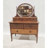 Early 19th century dressing chest with oval bevel edged mirror above the superstructure, on two
