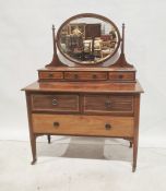 Early 19th century dressing chest with oval bevel edged mirror above the superstructure, on two