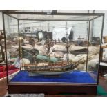 Painted wooden model of The Royal Yacht Caroline 1749, in glazed and stained wood table-top cabinet,