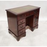 Reproduction kneehole desk with green leather inset top, mahogany body, eight assorted drawers and