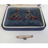 Pair of gold-coloured drop earrings hung with garnet beads and a bar-brooch set with green paste