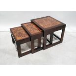 Mid-century nest of three tables with tile tops, flowerhead design to the centre