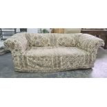 Victorian Chesterfield-type upholstered sofa with loose fitting covers, turned legs, modern roller