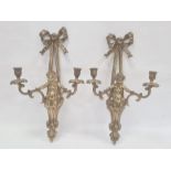 Pair of brass wall-mounted candle holders, each ribbon and putto decorated, 56cm high (2)