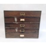 Five-drawer table-top cabinet containing watch springs, parts and clock faces, etc