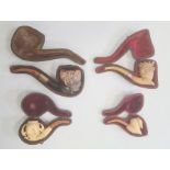 Four meerschaum pipes including Bacchanalian male head, medium sized lady and bonnet, small spaniel,