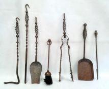 Set of four iron fireside implements with open spiral twist and hook handles, a similar shovel and