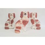 Pair of Staffordshire pottery models of spaniels, 22cm high, and another similar, circa 1880, each