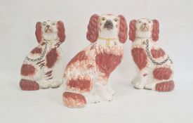 Pair of Staffordshire pottery models of spaniels, 22cm high, and another similar, circa 1880, each