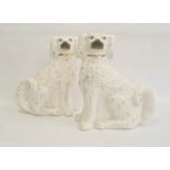 Pair of Staffordshire pottery models of spaniels, circa 1880, modelled in opposing directions, their