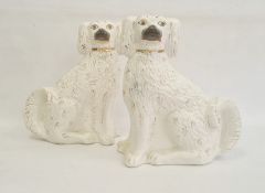 Pair of Staffordshire pottery models of spaniels, circa 1880, modelled in opposing directions, their
