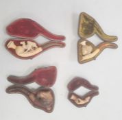 Four meerschaum and amber pipes decorated with Edwardian lady, camel, Middle Eastern gentleman and