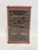 19th century mahogany wall-hanging corner cupboard with astragal-glazed door enclosing shelves, 91.