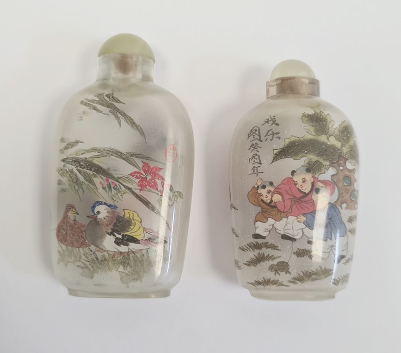 Two Chinese internally painted glass snuff bottles and stoppers, 8cm and 7cm high and a carved